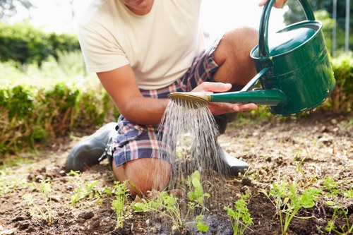 Maintenance crew mowing and pruning in an urban garden